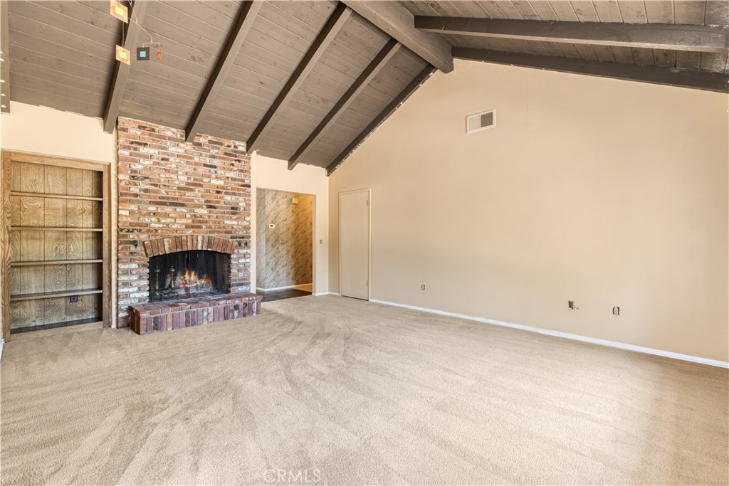 Original great room with brick fireplace before the remodel