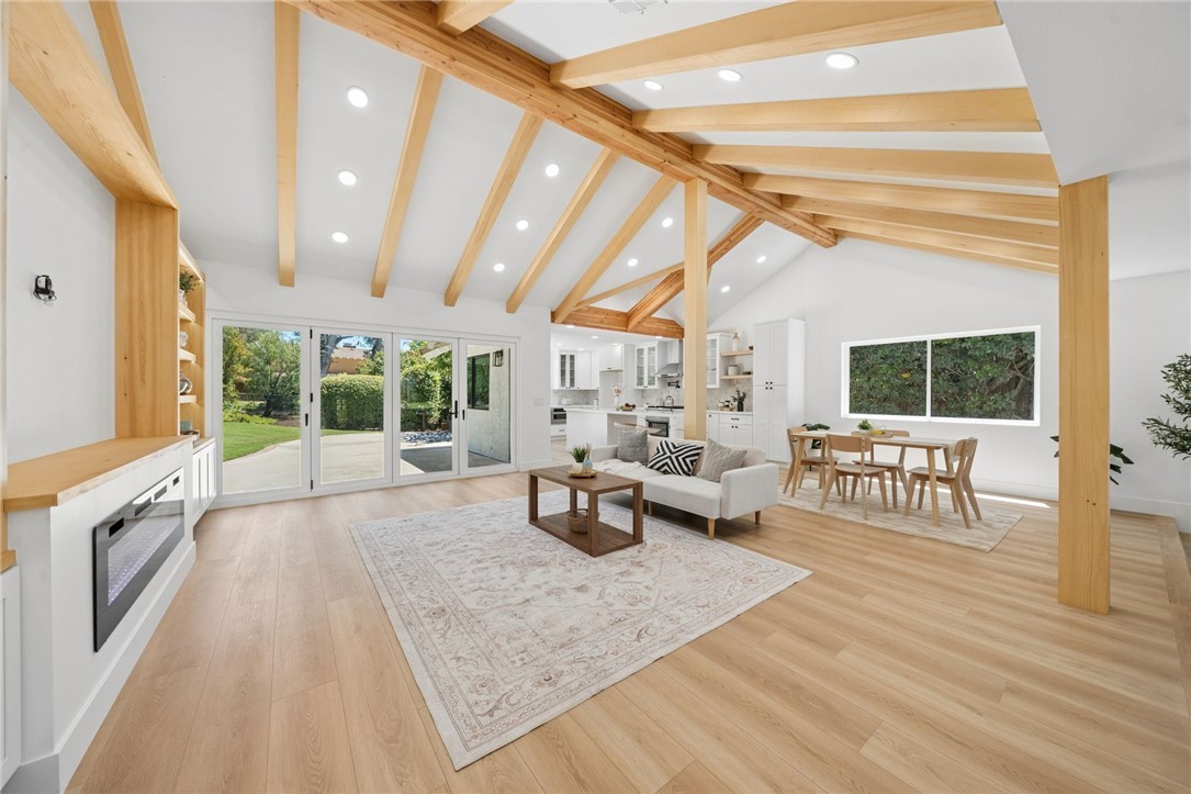 Vaulted great room with exposed beams after the remodel